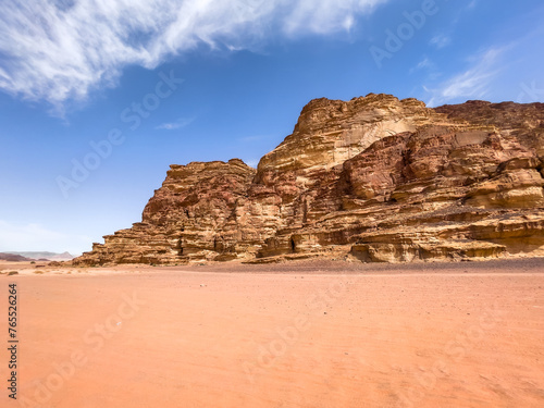 Desert landscape in the hot summer showing the red sand and rock formations