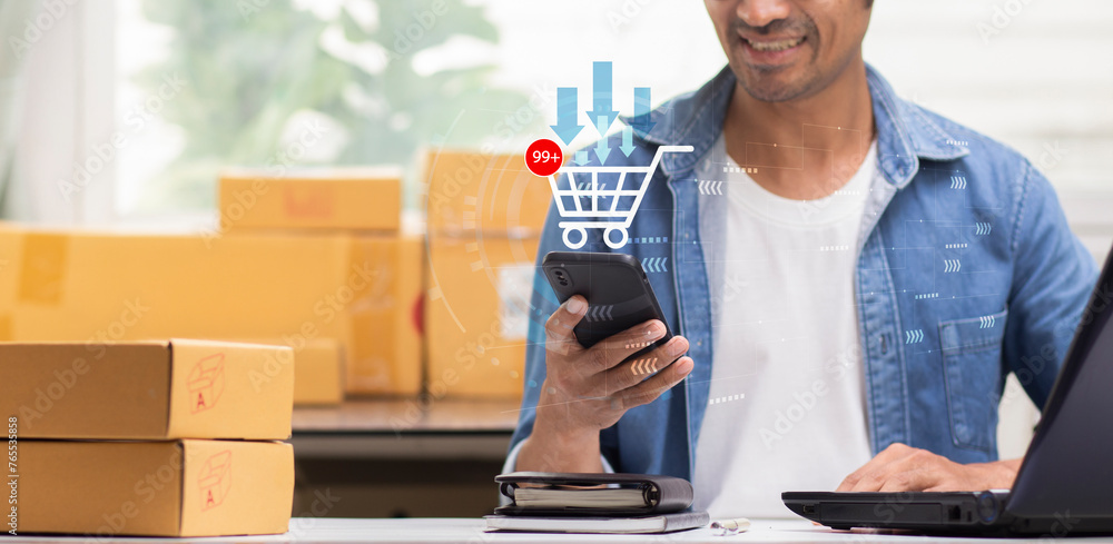 man happy and smiling during using smartphone with orders in shopping cart icon during working at home ,online business, e-commerce marketplace concept man happy and smiling during using smartphone with orders in shopping cart icon during working at home ,online business, e-commerce marketplace concept