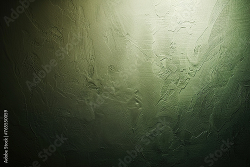horizontal image of a green textured dark background partially illuminated