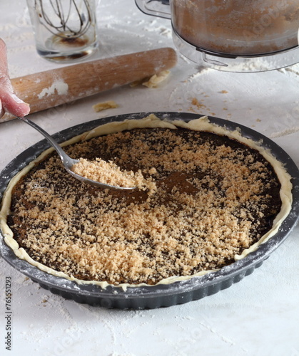 Sprinkle filling mixture over molasses and egg mixture. Making Treacle Pie Series. © ffolas