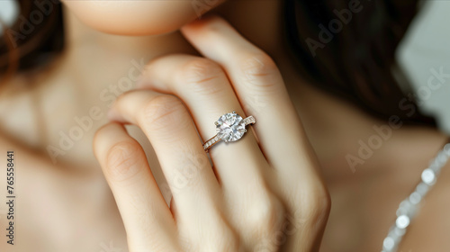 Close-up of a diamond ring on a woman's ring finger.