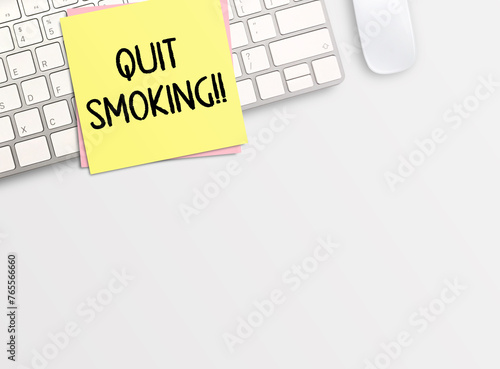 Top view with quit smoking in stickynote  and keyboard on white table background. photo