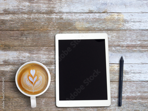 Top view Minmal workspace with tablet, headphones and coffee cup on wood table background. photo