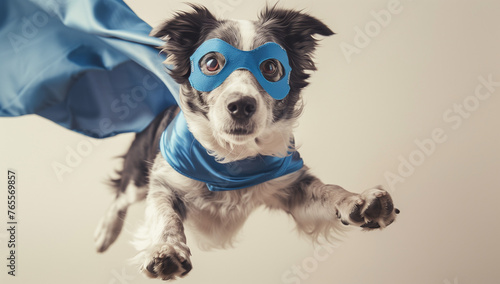 A superhero dog with a blue cloak and mask, flying in the air against a light pastel background © Maru_sua