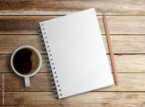 blank notebook and coffee on wood table background