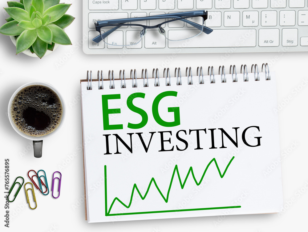 Fototapeta premium ESG investing results sign on notebook with keyboard and coffee,smartphone,glasses on office desk.