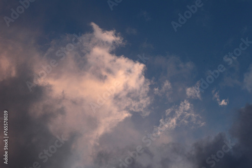 Nature wallpaper, light and dark clouds against a blue sky.