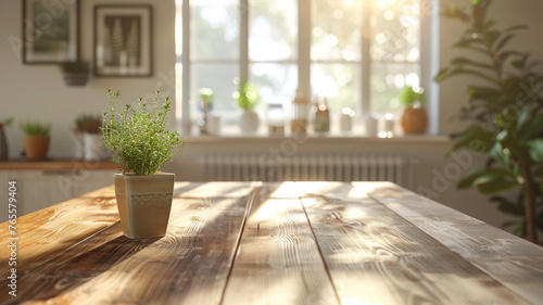 A potted plant sits on a wooden table in a sunlit room. The plant is a small herb plant, and it is placed in a vase. The room has a warm and inviting atmosphere