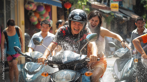 Songkran celebration Thailand Bangkok, Chiang Mai, New Yeah celebration in Thailand, Water fights all around the country.  Couple on the motor bike. The concept of Water Festival, splashing. © Natalia Schuchardt