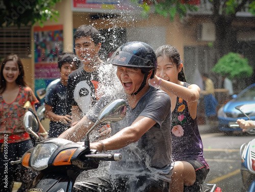 Songkran celebration Thailand Bangkok, Chiang Mai, New Yeah celebration in Thailand, Water fights all around the country.  Couple on the motor bike. The concept of Water Festival, splashing.