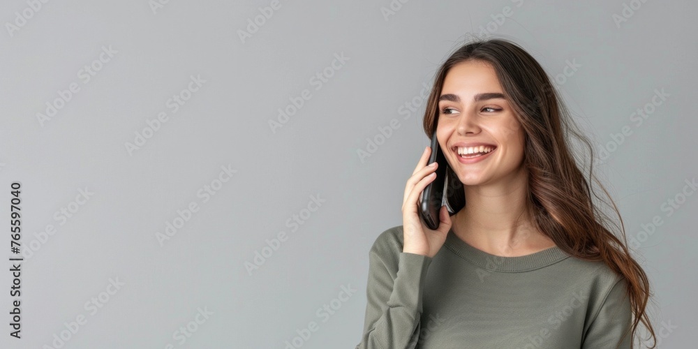 Smiling business woman talking on the phone Horizontal banner on the studio wall Smiling business woman talking on the phone Horizontal banner on the studio wall