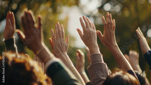 Uplifted hands against a golden backdrop, a universal gesture of participation.