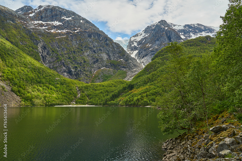Blue Bondhusbreen Glacier hanging in the mountains over the Bondhusvatnet Lake and in Sundal, Vestland, Norway Blue Bondhusbreen Glacier hanging in the mountains over the Bondhusvatnet Lake and in Sundal, Vestland, Norway