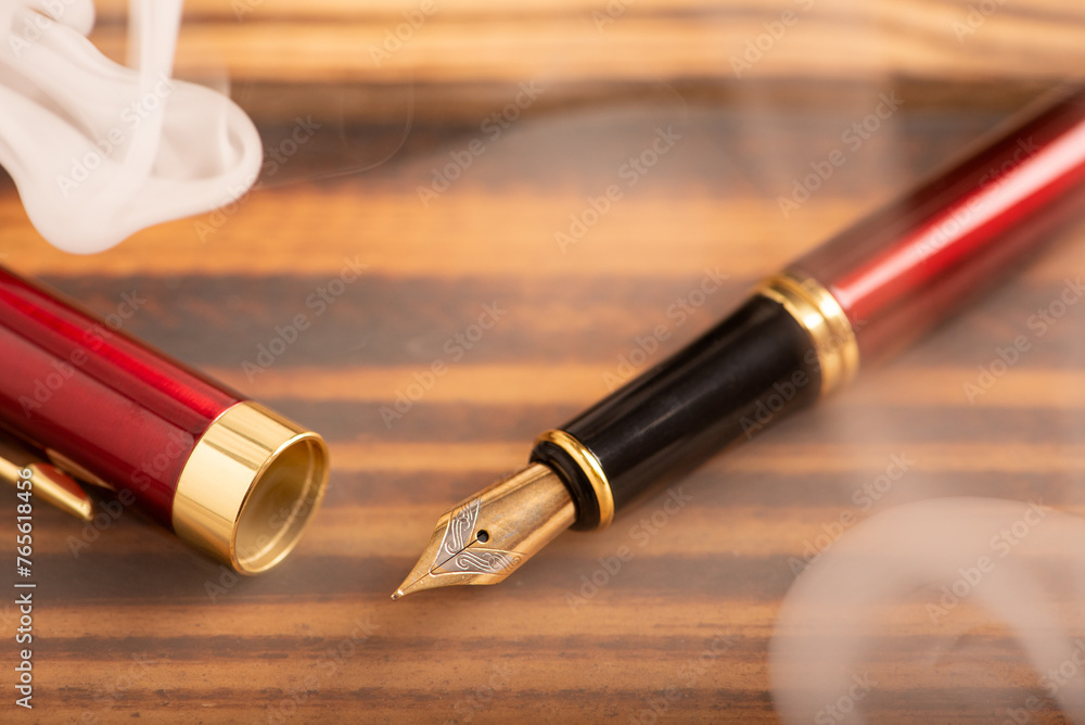 Fountain pen, old and beautiful fountain pen placed on rustic wood and dark background, selective focus. Fountain pen, old and beautiful fountain pen placed on rustic wood and dark background, selective focus.