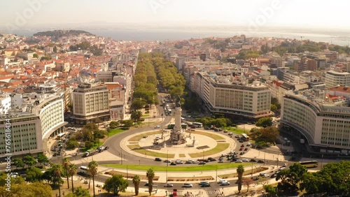 Aerial Panning Shit Of Marquis Of Pombal Square At Roundabout Amidst Buildings In Residential City On Sunny Day - Lisbon, Portugal photo