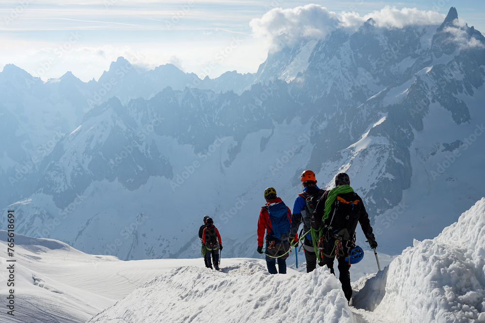 Group of experienced mountaineers ascending Mont Blanc on sunny day, Chamonix, France