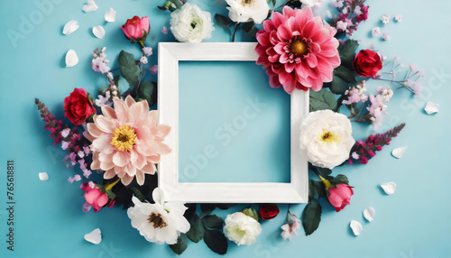 Top view of Beautiful flowers and blank frame on blue background with copy space