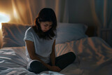 Asian girl feeling sad and lonely in the bedroom under dim light