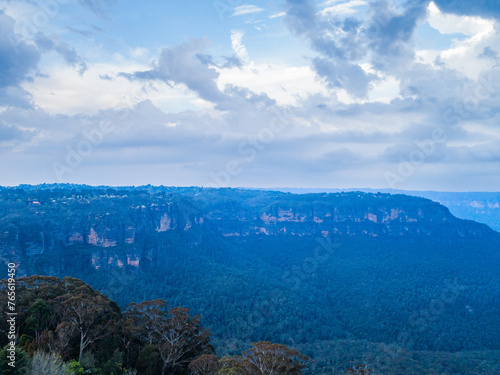 Gum trees in foreground of view over national park in Blue Mountains Katoomba