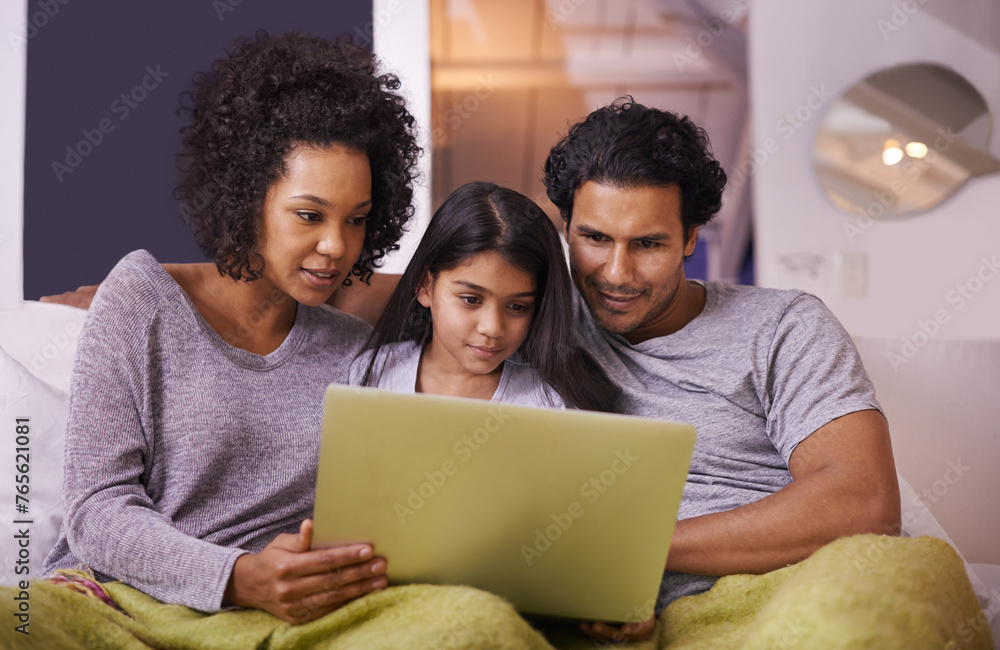 Fototapeta premium Family, girl and sofa with laptop to watch movie on online website for educational programs or child development. Parents, home and bonding with streaming cartoon in living room, learning and support