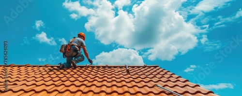 Roofing tiles installation in process. Contruction worker doing tiles on new house