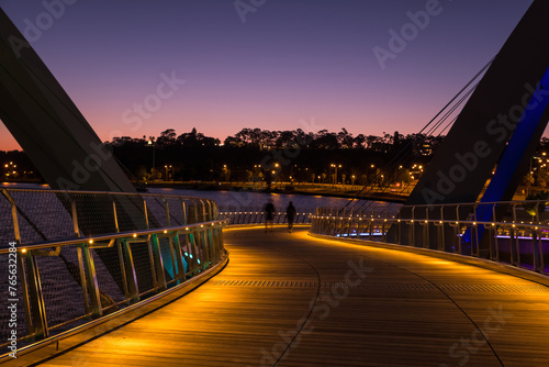 Twilight scene on bridge with two people walking at Elizabeth Quay photo