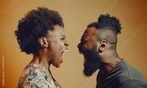 man and woman yelling at each other fighting in bad marriage isolated on plain yellow colour studio background © Ricky