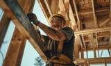 Skilled carpenter marks measurements on wooden beams during the early stages of residential framing