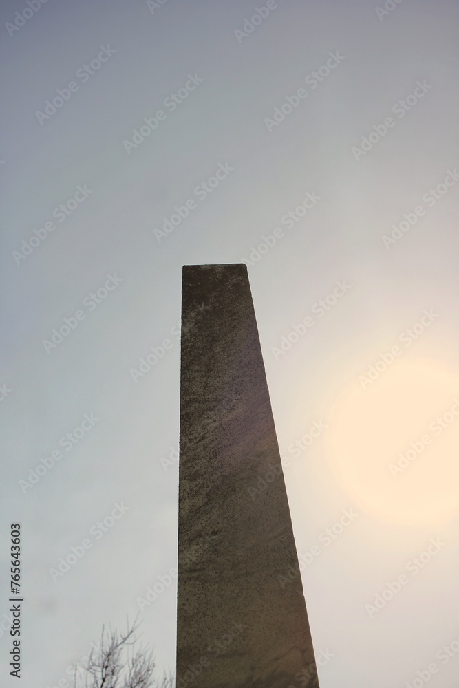 A tall stone obelish tower standing against the sky. A tall stone obelish tower standing against the sky.