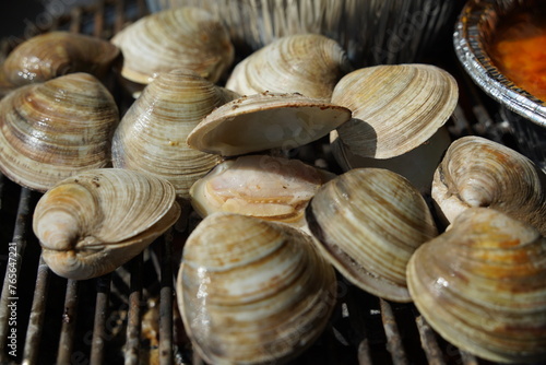 Fresh clams are grilled on a brazier and eaten.