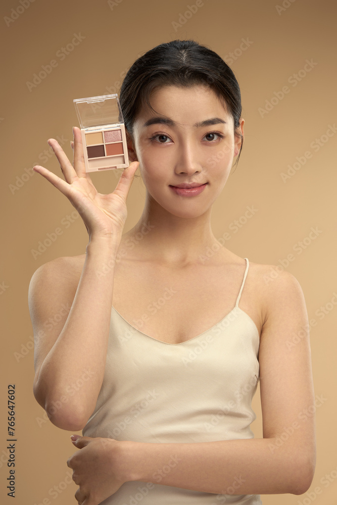 Young beauty with eye shadow box Young beauty with eye shadow box