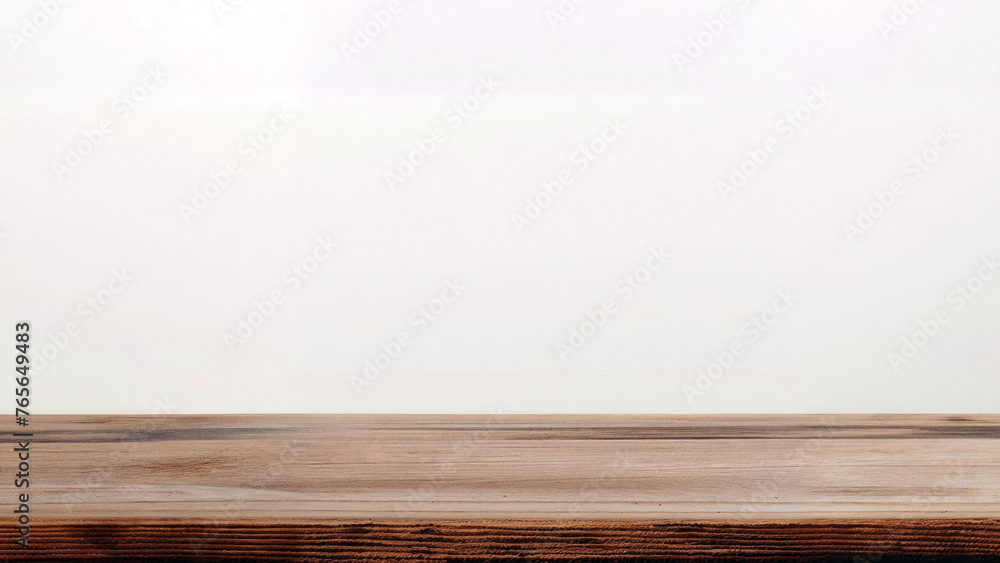 Wooden table with a white wall in the background. High quality photo