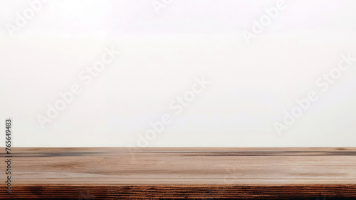 Wooden table with a white wall in the background. High quality photo