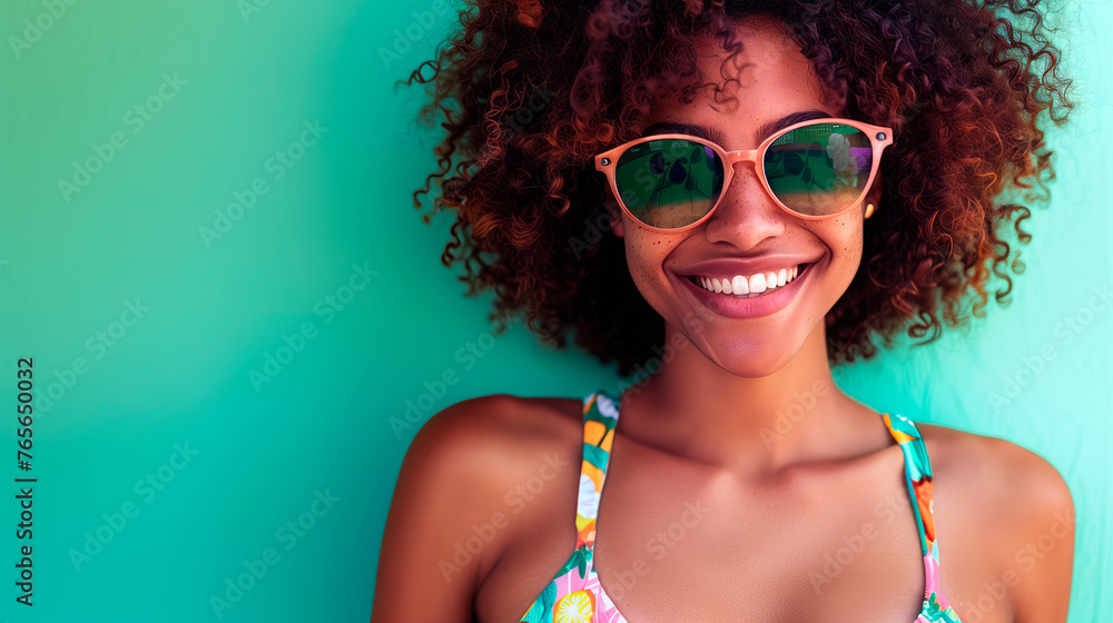 Summer fashion portrait of young woman wearing hawaiian dress over green background. Colourful summer style portrait with empty space for text or product presentation.