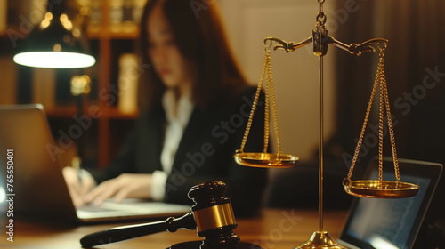 Lawyer working late in office, focused on laptop with scales of justice and gavel
