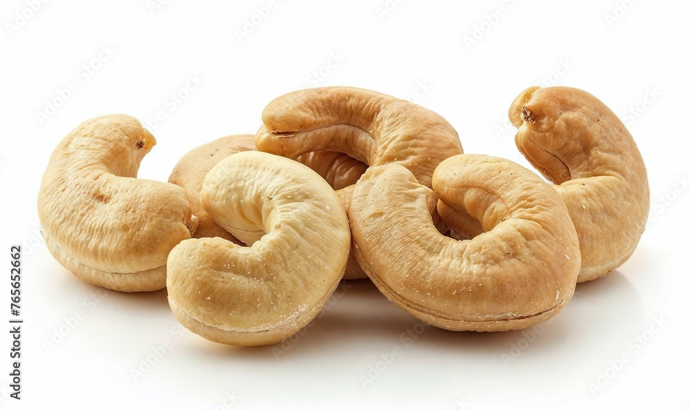 Delicious fresh roasted cashew nuts close up macro shot isolated on white background Delicious fresh roasted cashew nuts close up macro shot isolated on white background
