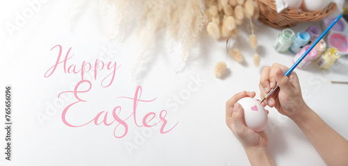 Hand holding an egg. Decorating Easter egg.