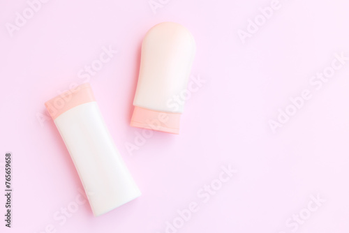 Cosmetic bottle containers isolated on pink background, Beauty products