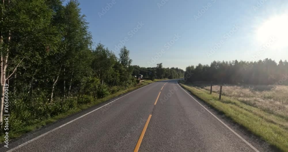 Driving a Car on a Road in Norway at dawn. Driving a Car on a Road in Norway at dawn.
