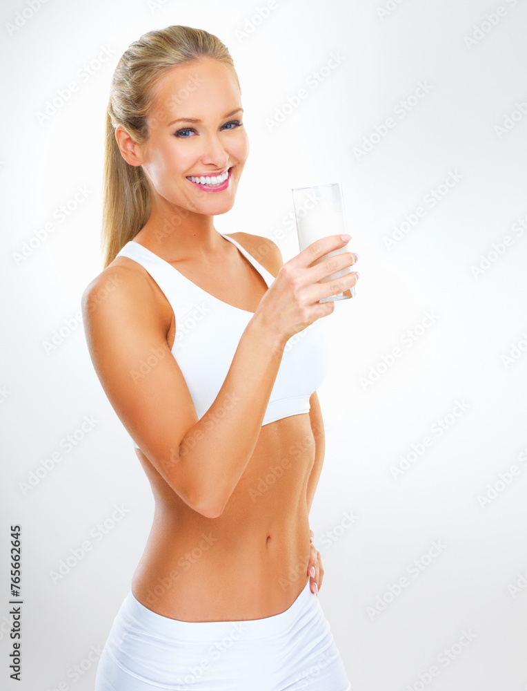 Portrait, woman and glass of milk for fitness in studio with nutrition, vitamins and calcium in white background. Organic, healthy lifestyle and wellness for diet with dairy product and mockup space Portrait, woman and glass of milk for fitness in studio with nutrition, vitamins and calcium in white background. Organic, healthy lifestyle and wellness for diet with dairy product and mockup space