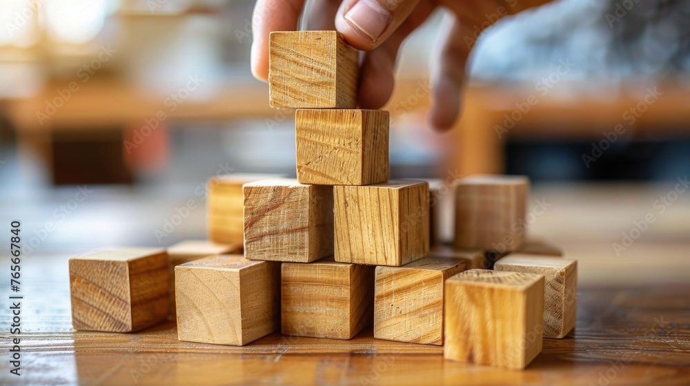 Person Placing Wooden Block in Pyramid Person Placing Wooden Block in Pyramid