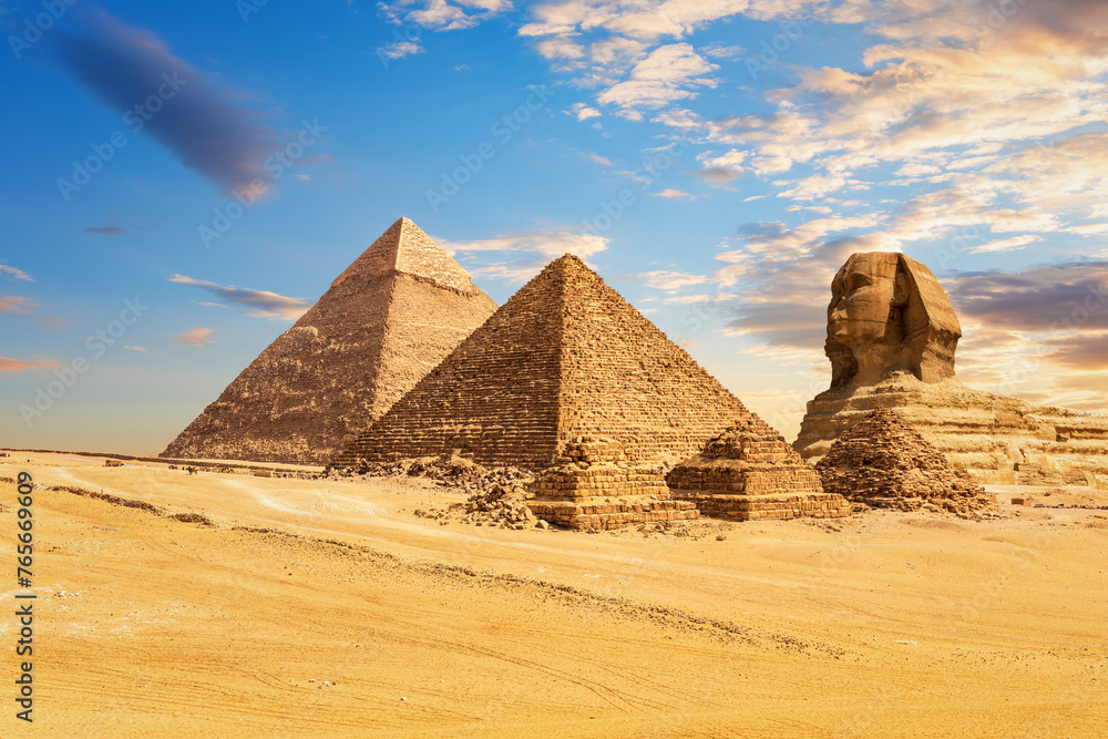 The Sphinx of Giza next to the Pyramids of Egypt and its companions in the sands of Giza desert, Egypt