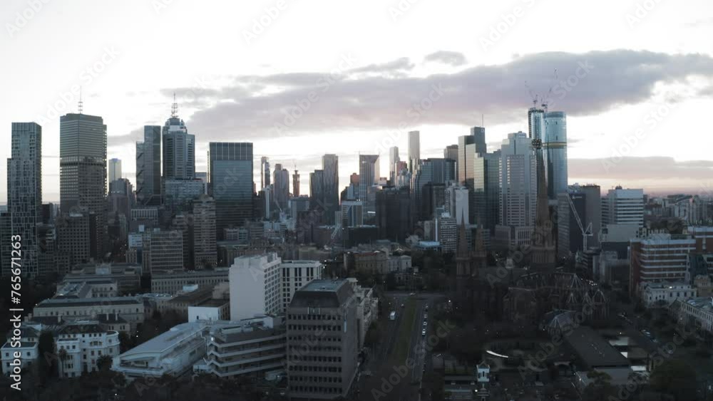 Aerial Backward Shot Of Famous Roman Catholic Church In Modern City Under Cloudy Sky - Melbourne, Australia Aerial Backward Shot Of Famous Roman Catholic Church In Modern City Under Cloudy Sky - Melbourne, Australia