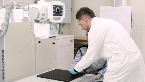 In a modern medical clinic, a young patient gets an x-ray of her arm after an injury. The concept of modern medical technologies, healthcare and treatment.