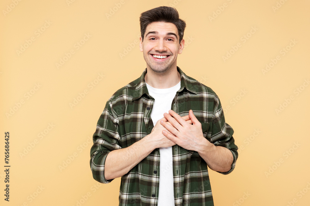 Cheerful man making a heartfelt gesture to express gratitude and thankfulness Cheerful man making a heartfelt gesture to express gratitude and thankfulness