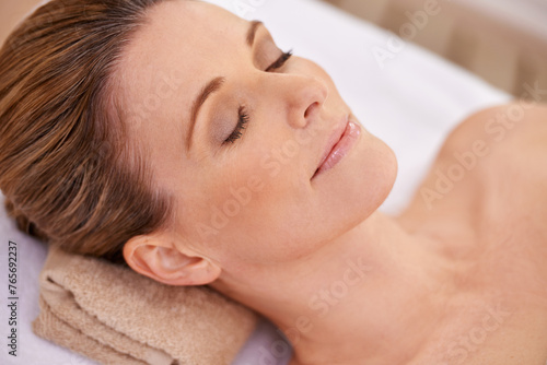 Woman, face and spa with massage for wellness, eyes closed with calm for zen and self care. Cosmetics, beauty and facial, relax and peace at luxury resort with treatment for stress relief and healing