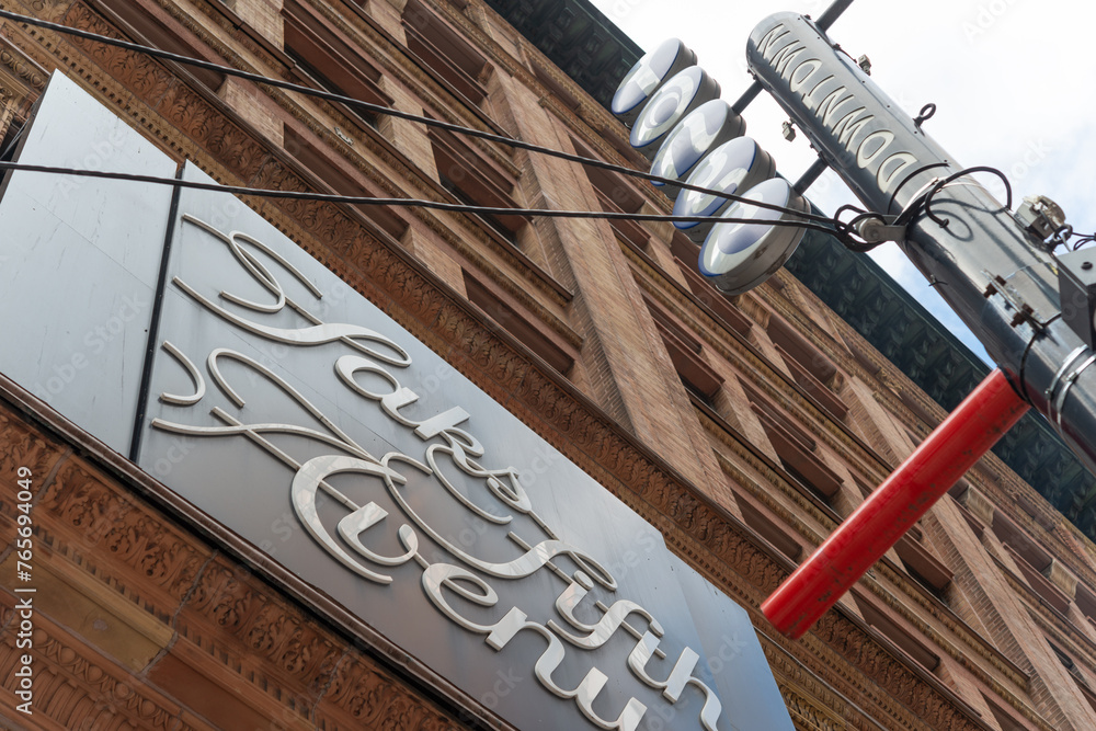 looking up at signs outside Saks Fifth Avenue, a department store