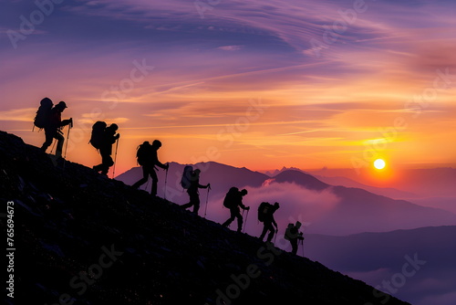 Landscape of hikers going down a hill during sunset