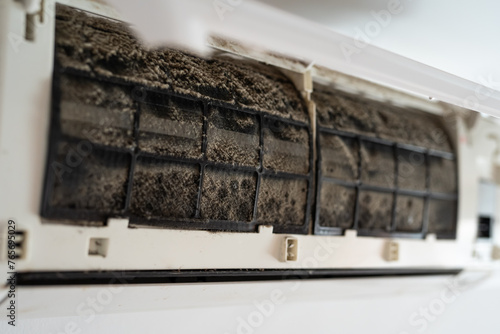 Dirty in dust and mold air conditioner filter close-up. Home air conditioner maintenance.