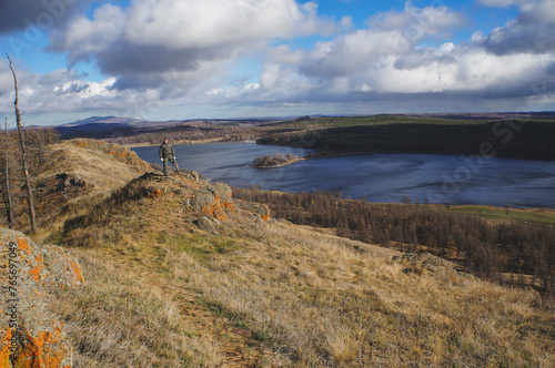 Cloudy sky over the lake creates a picturesque natural landscape on the hillside